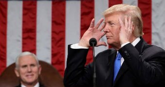 Donald Trump appears to hold his head during the SOTU address