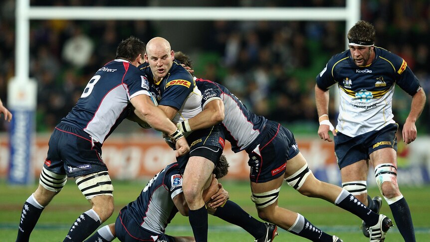 Torrid encounter ... Stephen Moore meets the Rebels' defence