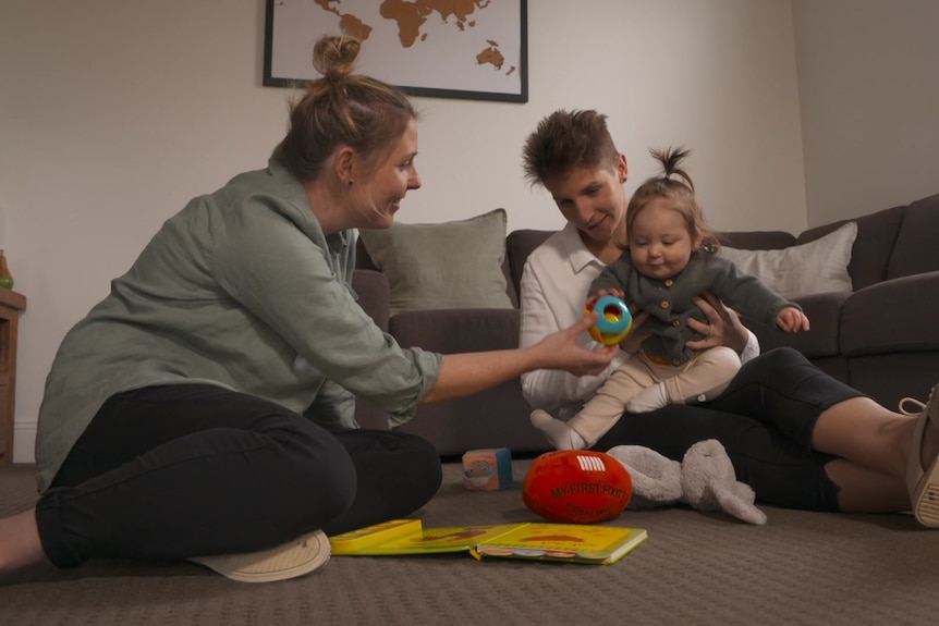 Emma Grant (right), her wife Leah French (left) and their daughter Poppy