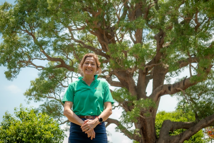Woman smiling on sunny day under a treee