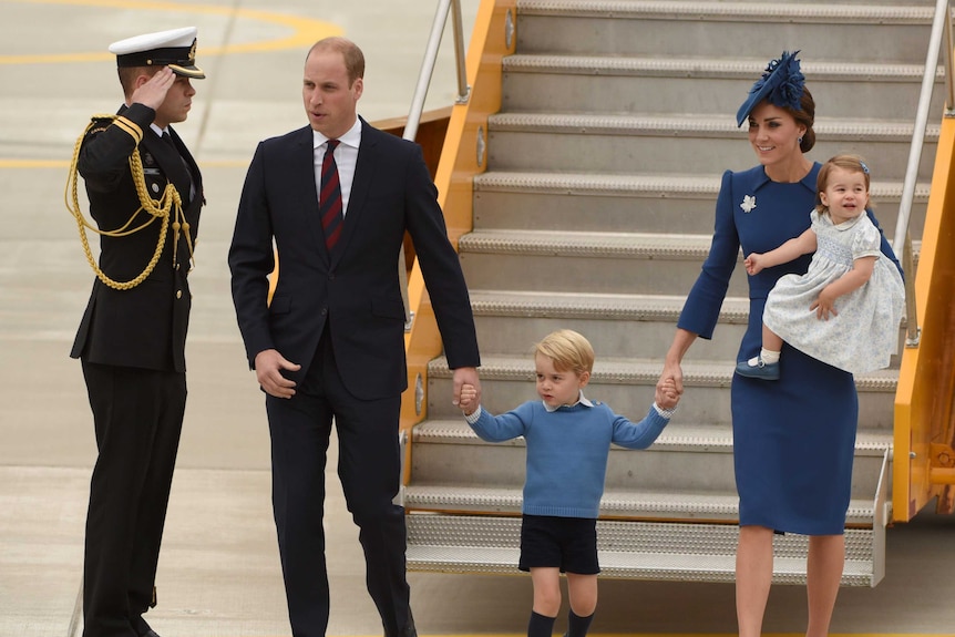 Prince William, Prince George of Cambridge, Catherine, Duchess of Cambridge and Princess Charlotte step of aeroplane stairs.