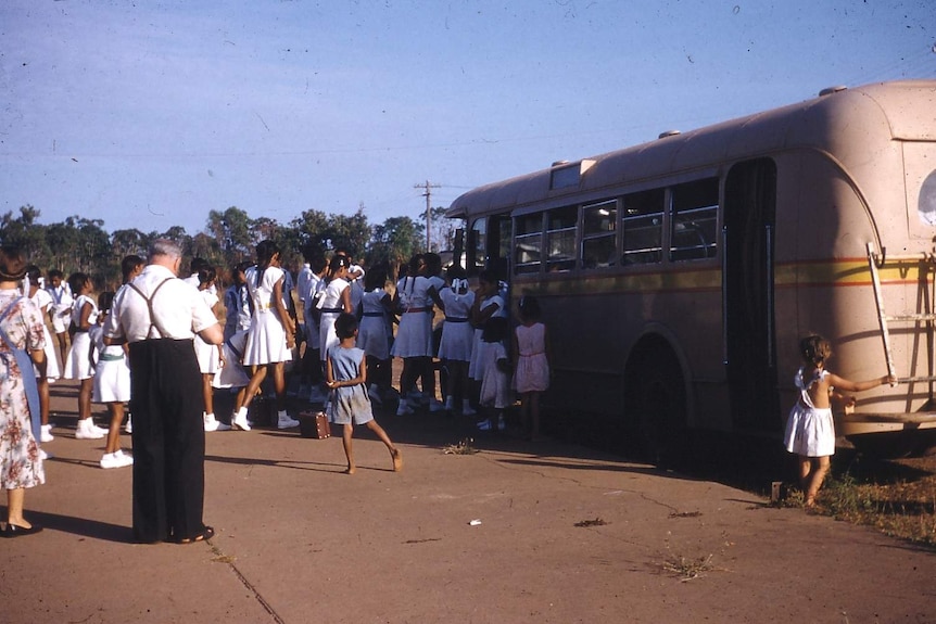 Children board a bus at Retta Dixon