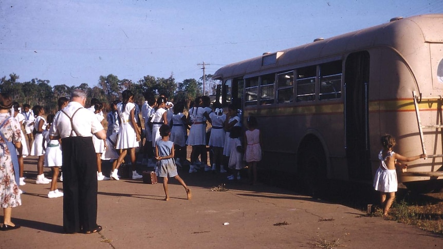 Children board a bus at Retta Dixon