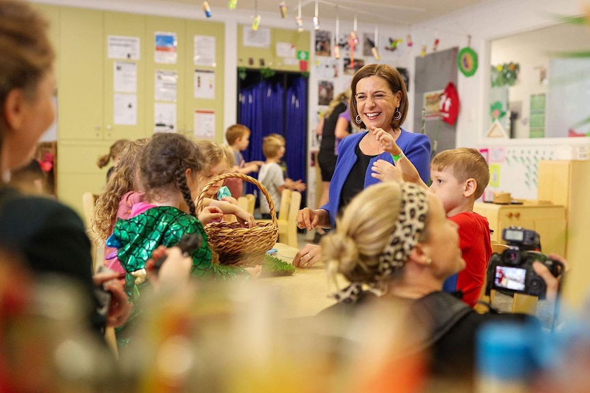 Deb Frecklington smiles while visiting children at an early education centre during the Queensland election campaign.