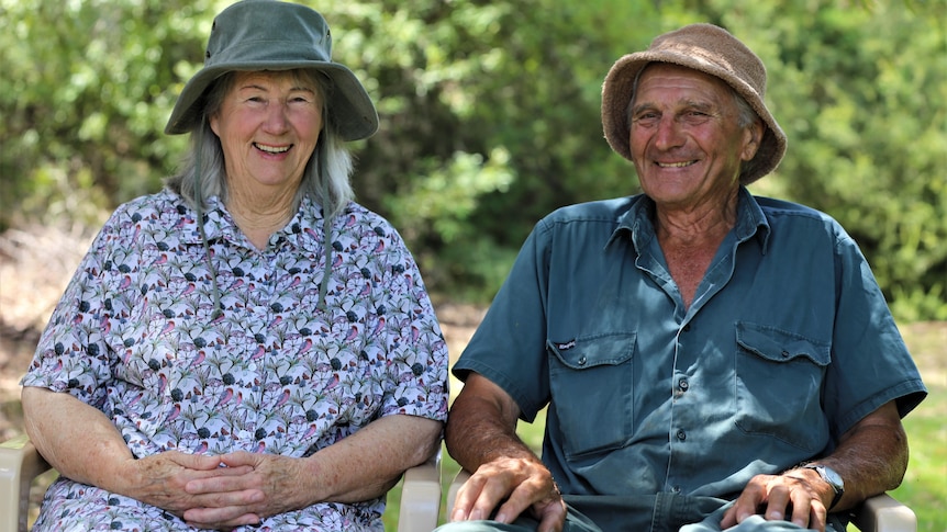 Photo of an older man and woman laughing and sitting together.