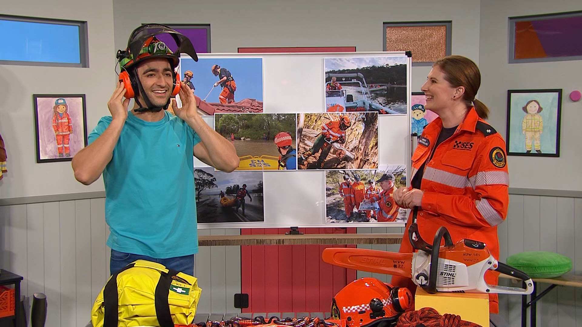 Matt wearing a helmet with a face shield and ear muff protectors with SES Volunteer Mara who is wearing her SES uniform
