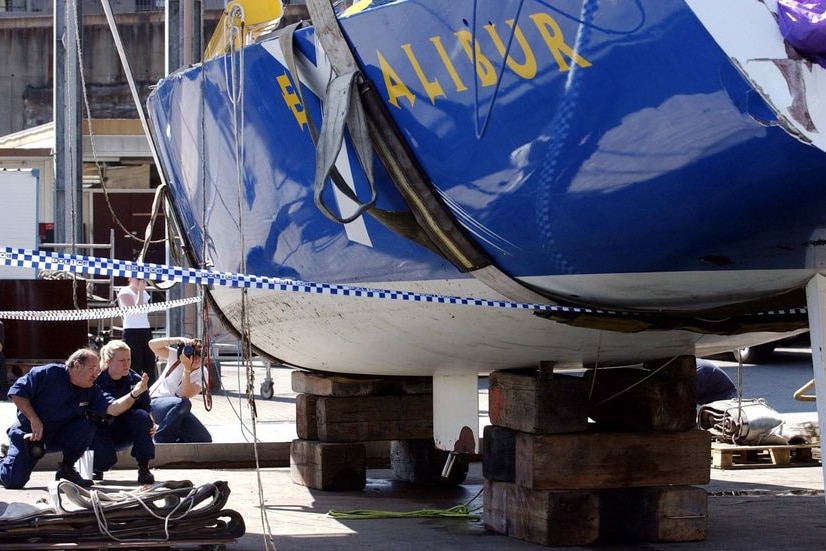 Forensic police examine the Excalibur after it was lifted from the water in 2002.