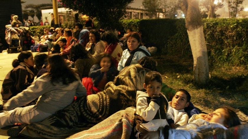 People spend the night outside their homes in Lima's port of Callao, after an earthquake struck Peru [File photo].