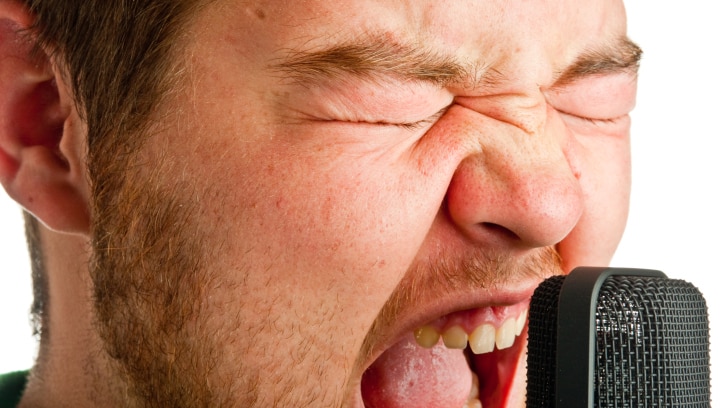 Man yelling into microphone