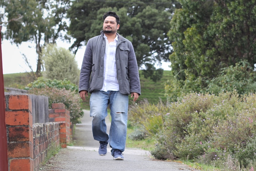 Anwarul Islam Khan walking down a street