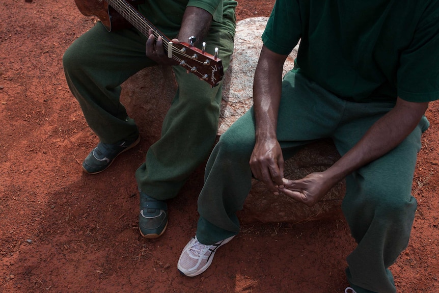 Two prisoners at the Eastern Goldfields Regional Prison play guitar and sing.