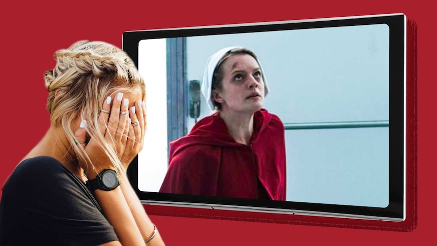 A woman covers her eyes in front of a TV screen showing a scene from the program The Handmaid's Tale.