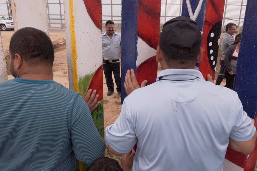 Families talk through the US-Mexico border fence.
