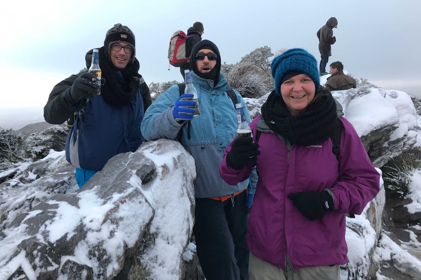 Locals enjoying a drink to celebrate the snow on Bluff Knoll.