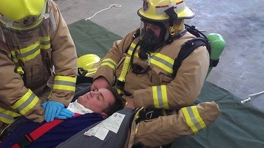 Three firefighters practise the new CPR drill