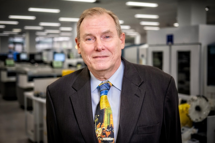 Professor Brian Lovell from the University of Queensland smiles at the camera while wearing a colourful tie