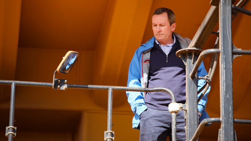WA premier Mark McGowan stands with his hands in his pockets looking downcast