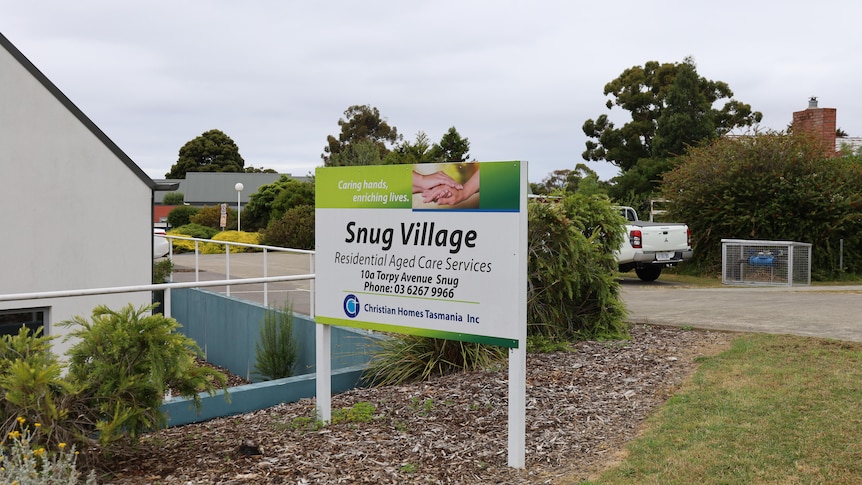 The front of and aged care facility with a sign that reads 'Snug Village Residential Aged Care Services'