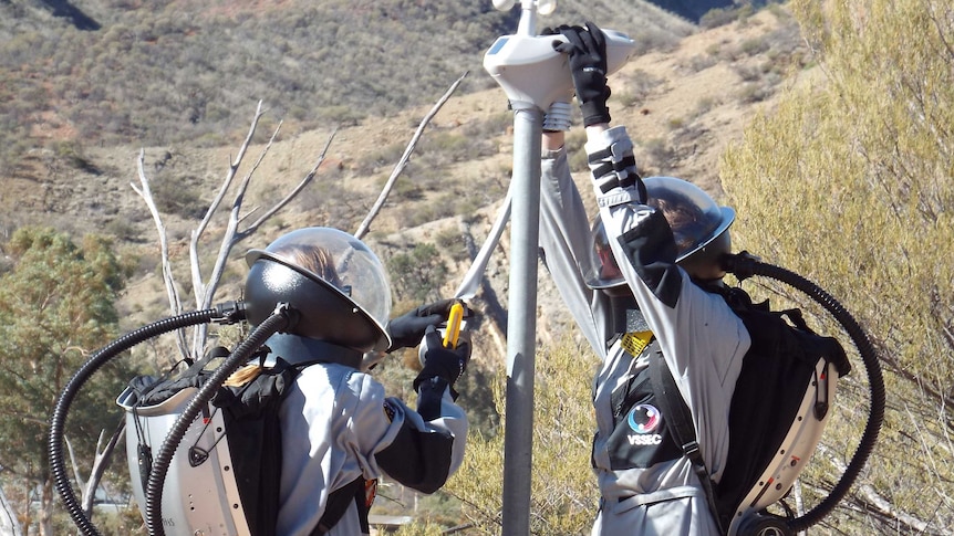 Simulation astronauts installing a weather station i