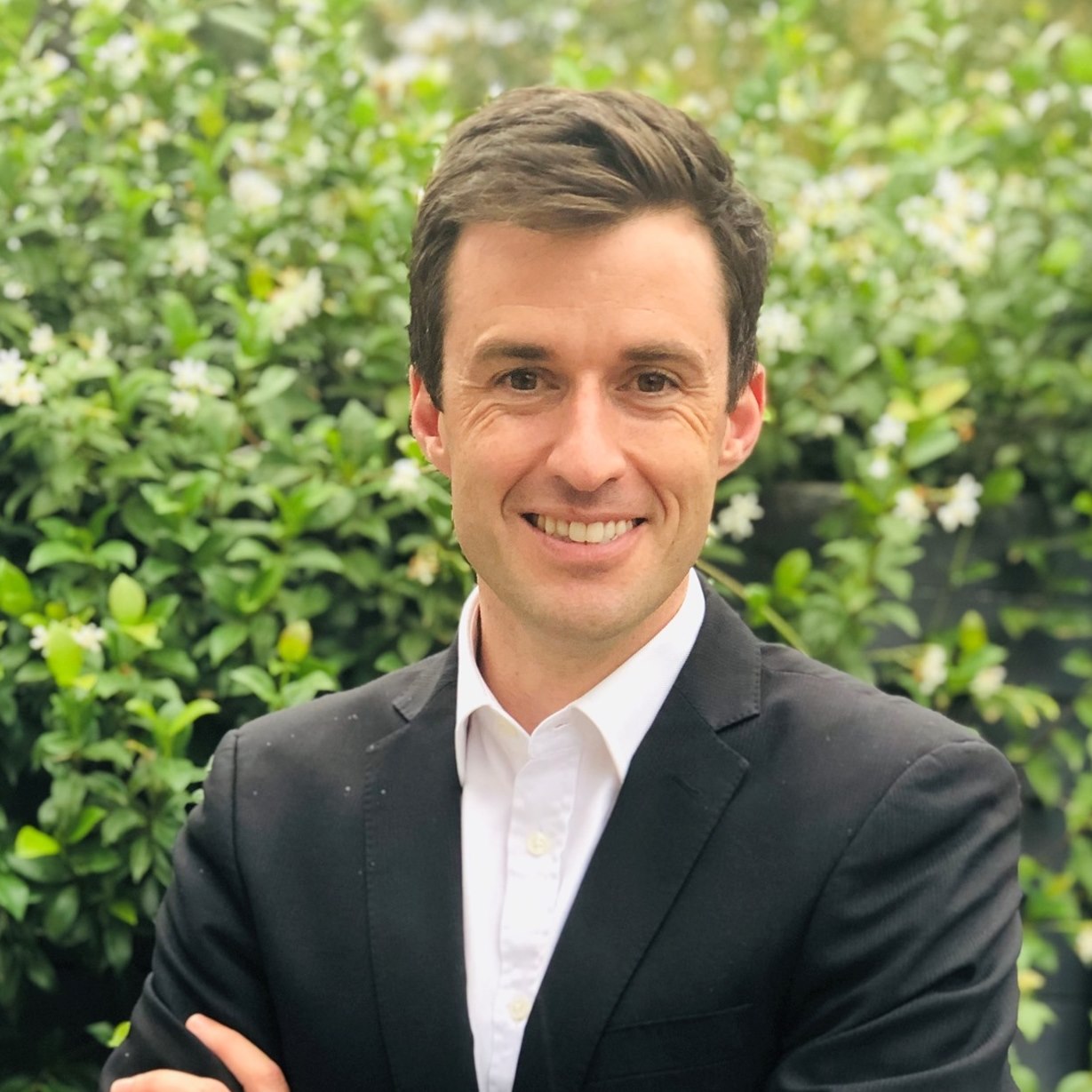 Eastern Metropolitan MP Matt Bach smiles in a garden.