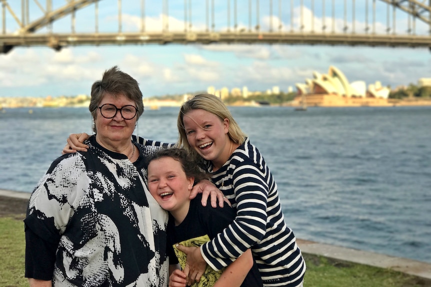 Poppy Starr Olsen and her grandmother Clair Thompson with Sydney Harbour Bridge and the Opera House in the background