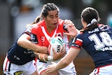 Female rugby league players in a tackle during a match