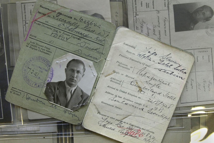 Black and white documents of a man in his thirties with tanned skin, piercing eyes, and sandy blond hair in a suit.