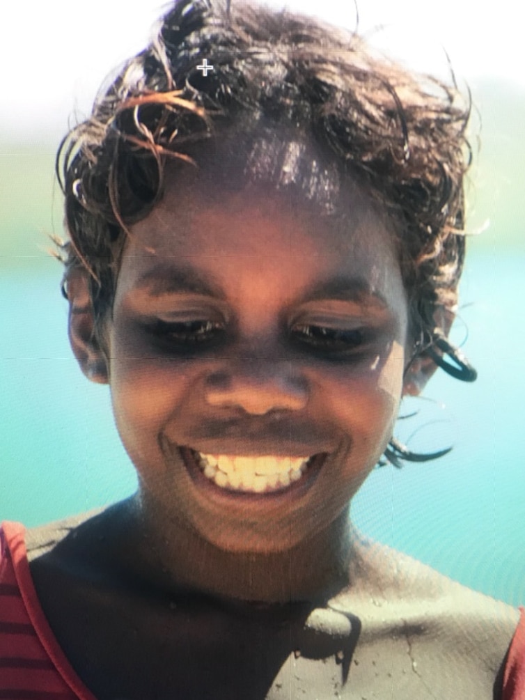 A headshot of a young Indigenous girl, smiling.