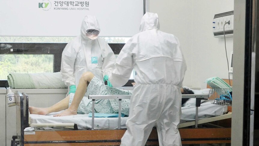 Medical workers caring for a MERS patient in hospital