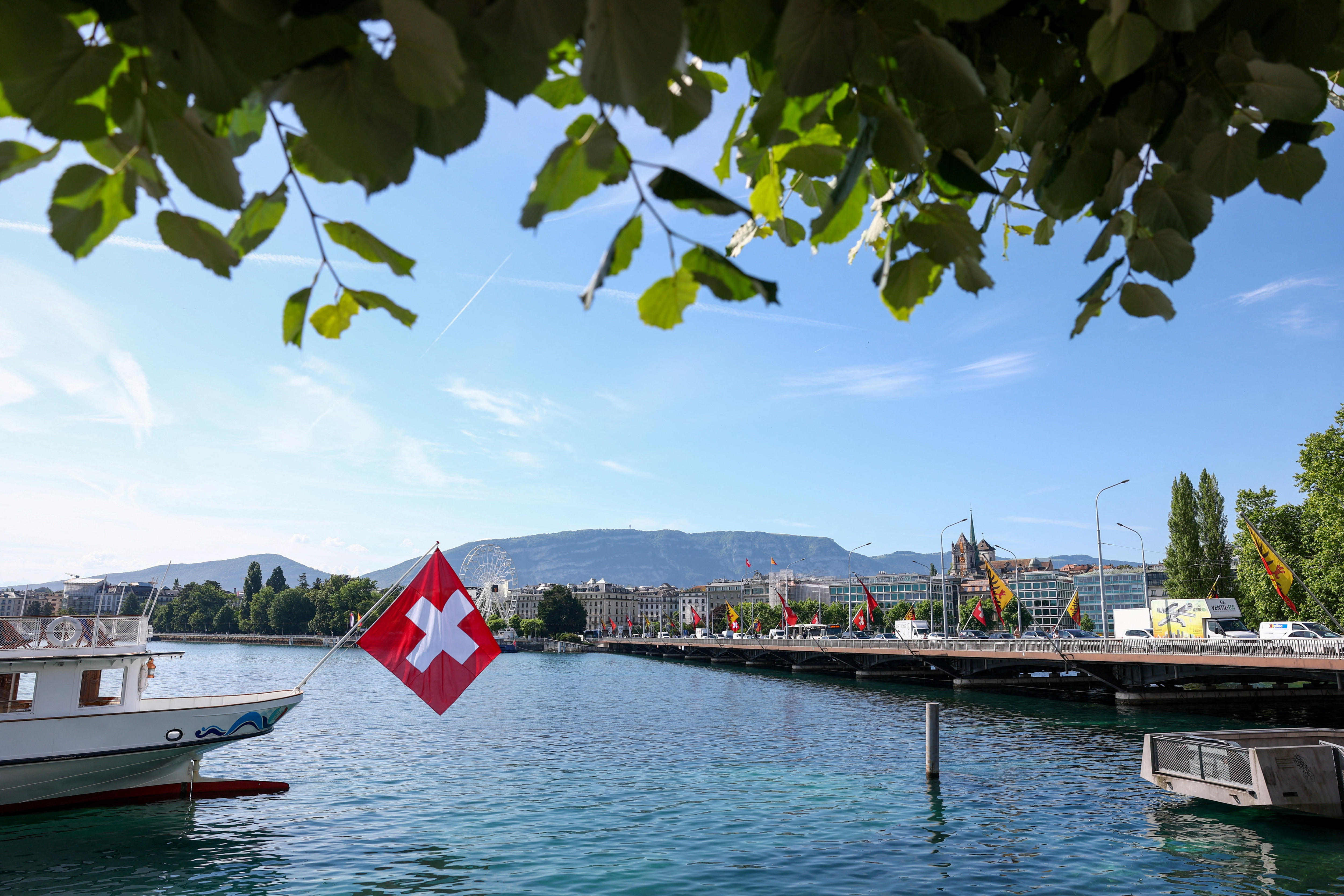 A Swiss flag in front of the Mont-Blanc bridge in Geneva