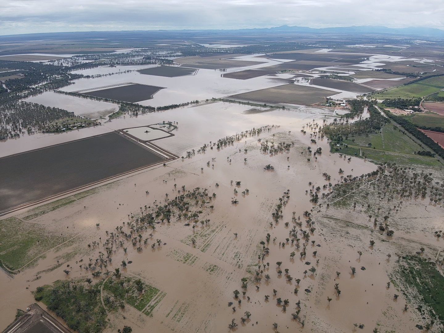 Floodwaters pool across crop plains.