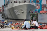 Investigators inspect pieces of the Sriwijaya Air flight SJ-182 retrieved from the Java Sea where the passenger jet crashed.