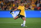 A Matildas player swings her leg through the ball to take a penalty kick during a shootout at the Women's World Cup.