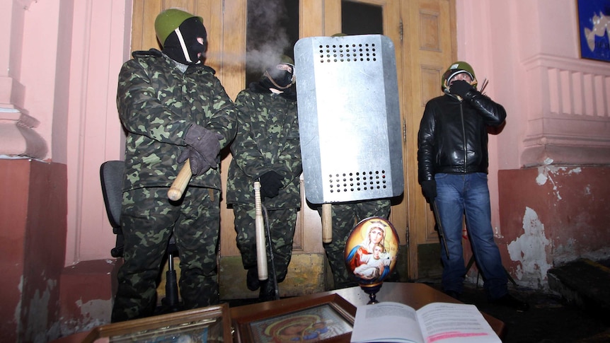 Ukrainian opposition activists guard the occupied justice ministry building