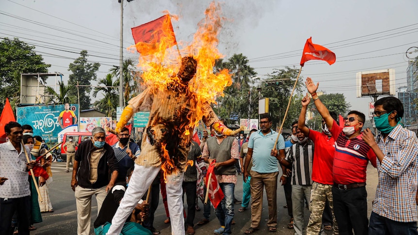 Supporters of leftist parties burn an effigy of Indian Prime Minister Narendra Modi