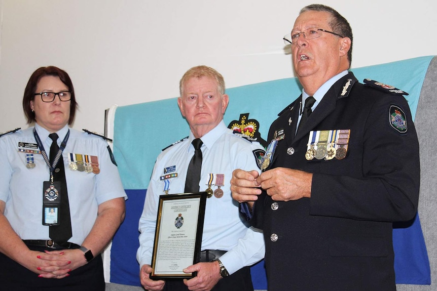 Police Commissioner Ian Stewart handing the award to Sergeant Thornton