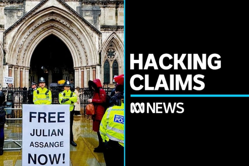 Hacking Claims: Police stand guard behind a pro-Julian Assange sign outside UK High Court