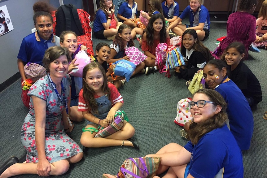 An academic talks to a group of girls in Western Cape York