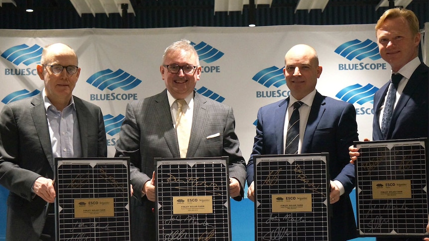 Company chiefs and NSW Energy Minister with miniature solar panels.