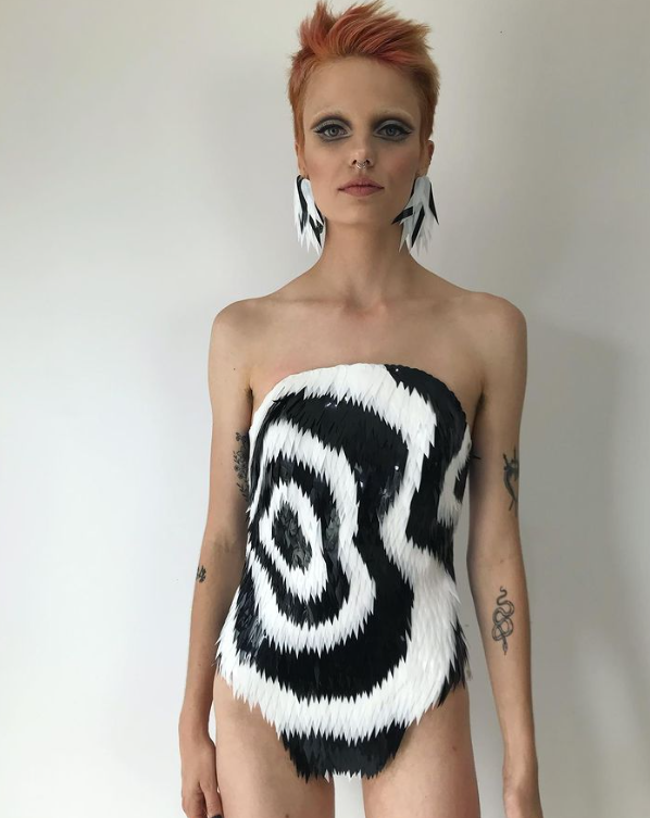 A model wearing a black and white jumpsuit. 