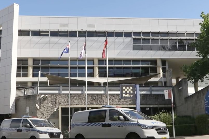 the outside of a building with a police cars parked out the front