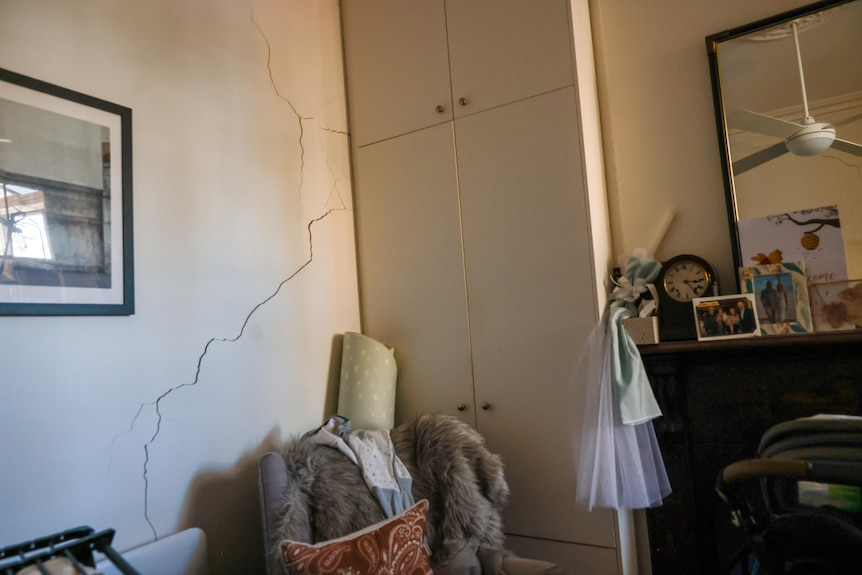 A cracked wall in a bedroom