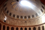 Worshippers gather in the rotunda of the Church of the Holy Sepulchre