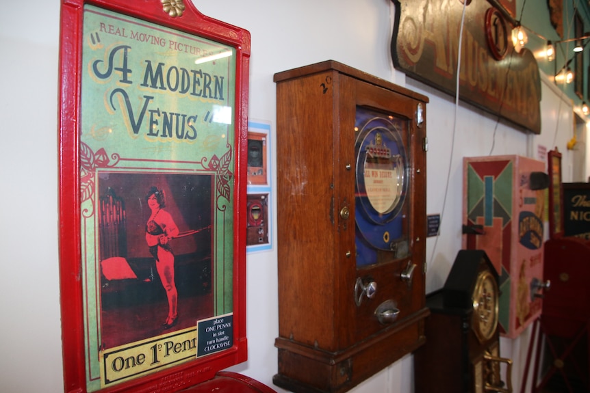 Several penny arcade machines attached to the wall at the museum 