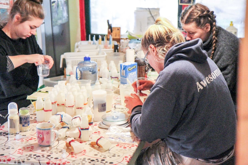 Volunteers prepare bottles.