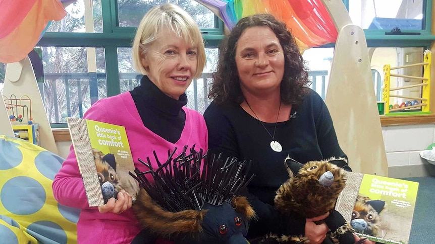 Judi Rhodes and Tanya McQueen holding their book Queenie's Little Book of Comfort