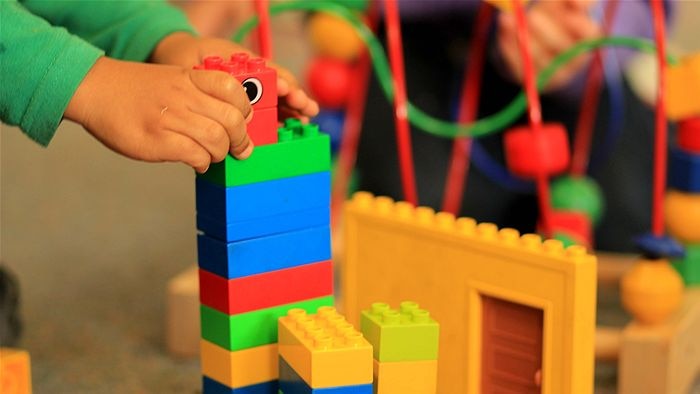 Child playing with lego.