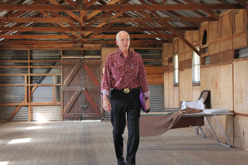 Dr Karl Kruszelnicki walks towards camera. He is in an old rundown shed.