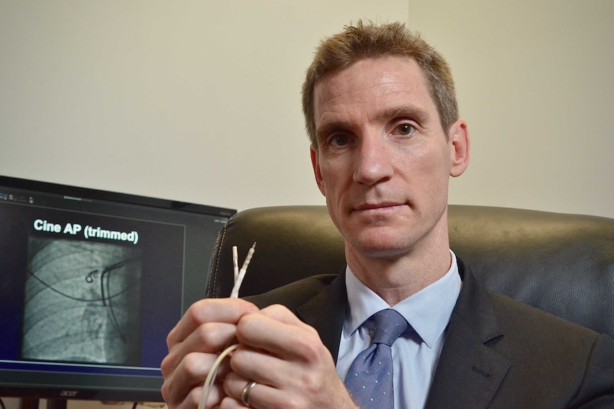 A man holding a faulty pacemaker device