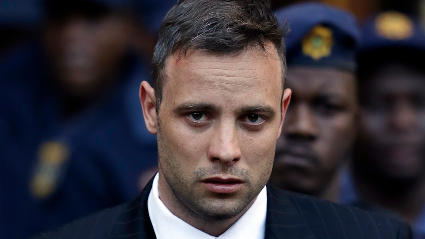 A close-up shot of a man with short hair and a stubble, not looking happy.
